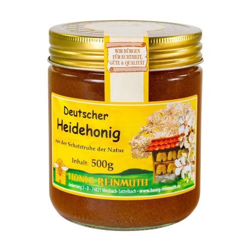 Glas mit goldenem Deckel und Etikett mit Banderole, gefüllt mit Honig