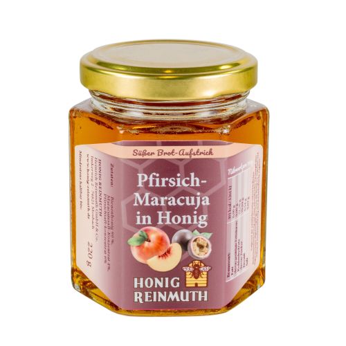 sechseckiges Glas mit goldenem Deckel mit Etikett gefüllt mit flüssigem Honig