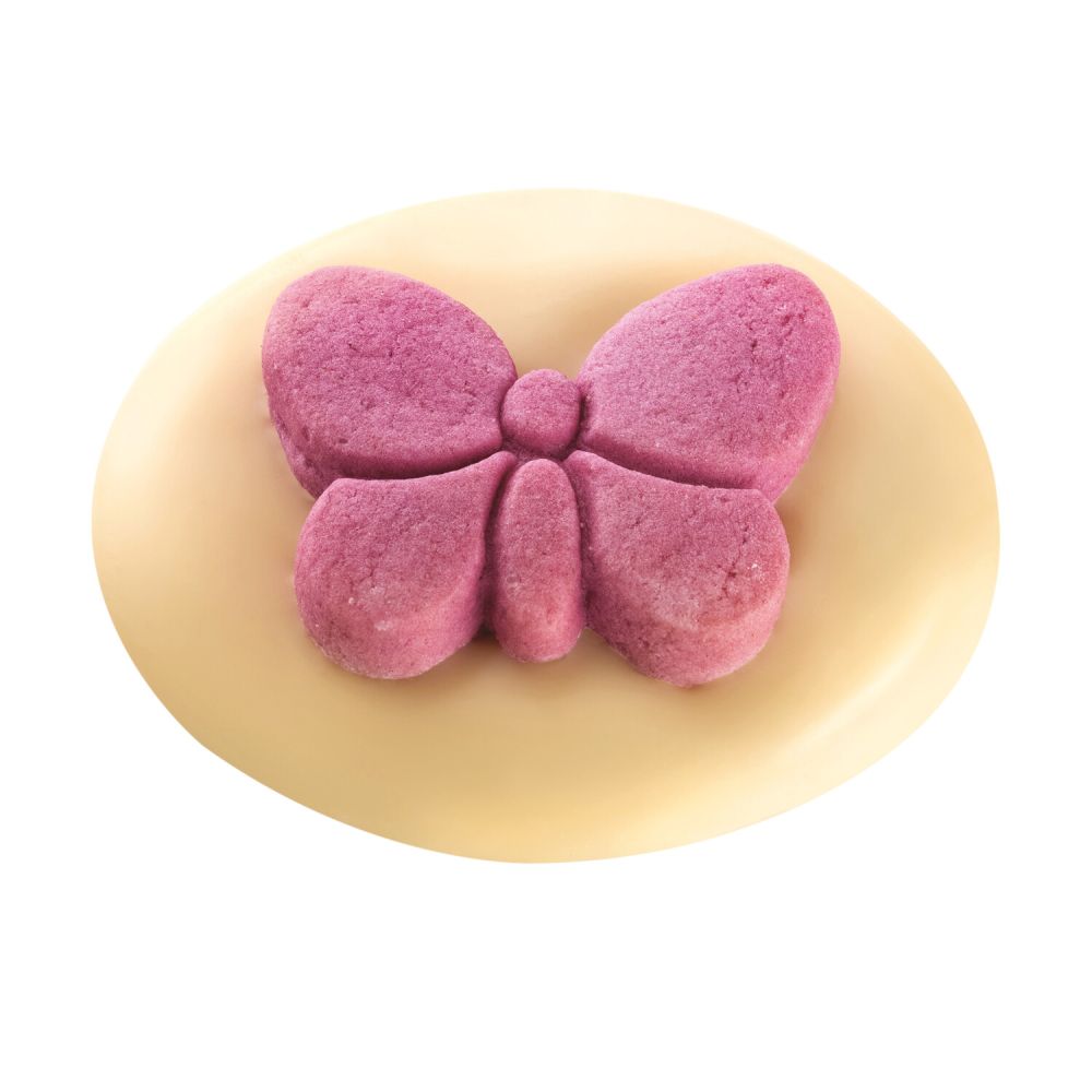 rundes Gebäck mit weißer Schokolade darauf ein rosa Schmetterling