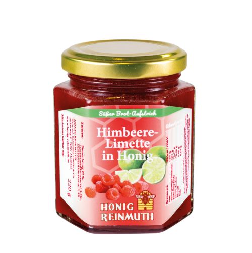Sechseckglas mit goldenem Deckel und Etikett Himbeere-Limette in Honig. Inhalt rote Farbe. 