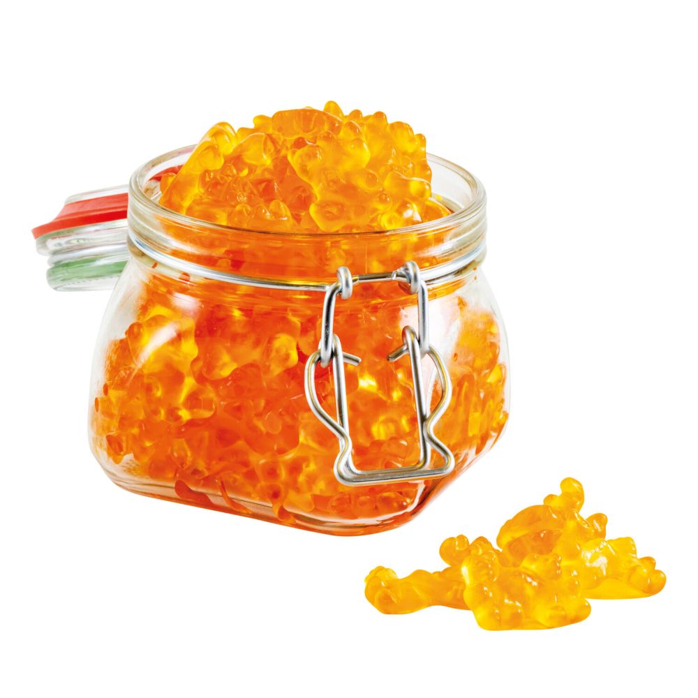 ein Bügelgas offen, gefüllt mit Honig-Doppelbärchen, vor dem Glas ein paar Bärchen lose