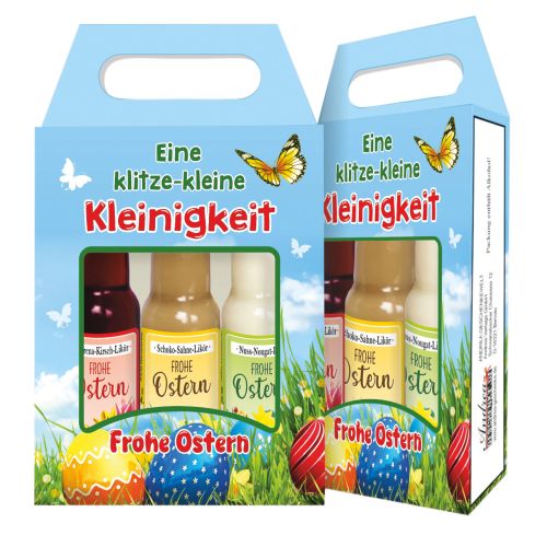 ein Karton frontal, einer seitlich mit Sichtfenster, darinnen 3 Fläschen zu erkennen. Die Kartons beschriftet und bunte Ostereier und Schmetterlinger aufgedruckt