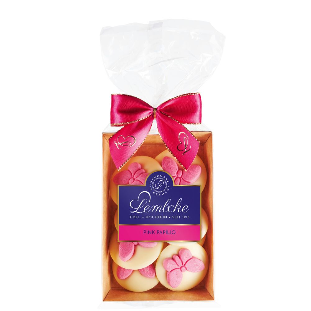 längliche Packung mit rosa Schleife und Etikett gefüllt mit Gebäck mit Schmetterlingen verziert