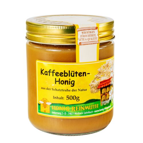 Glas mit goldenem Deckel und Etikett mit Banderole, gefüllt mit Honig