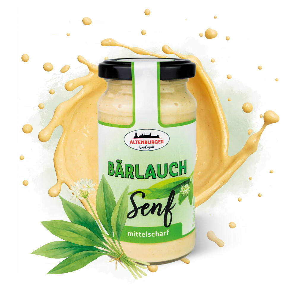 Glas mit Etikett und schwarzem Deckel, gefüllt mit hellem Senf. Hinter dem Glas ein Klecks Senf, vor dem Glas ein Bündel Senfblätter